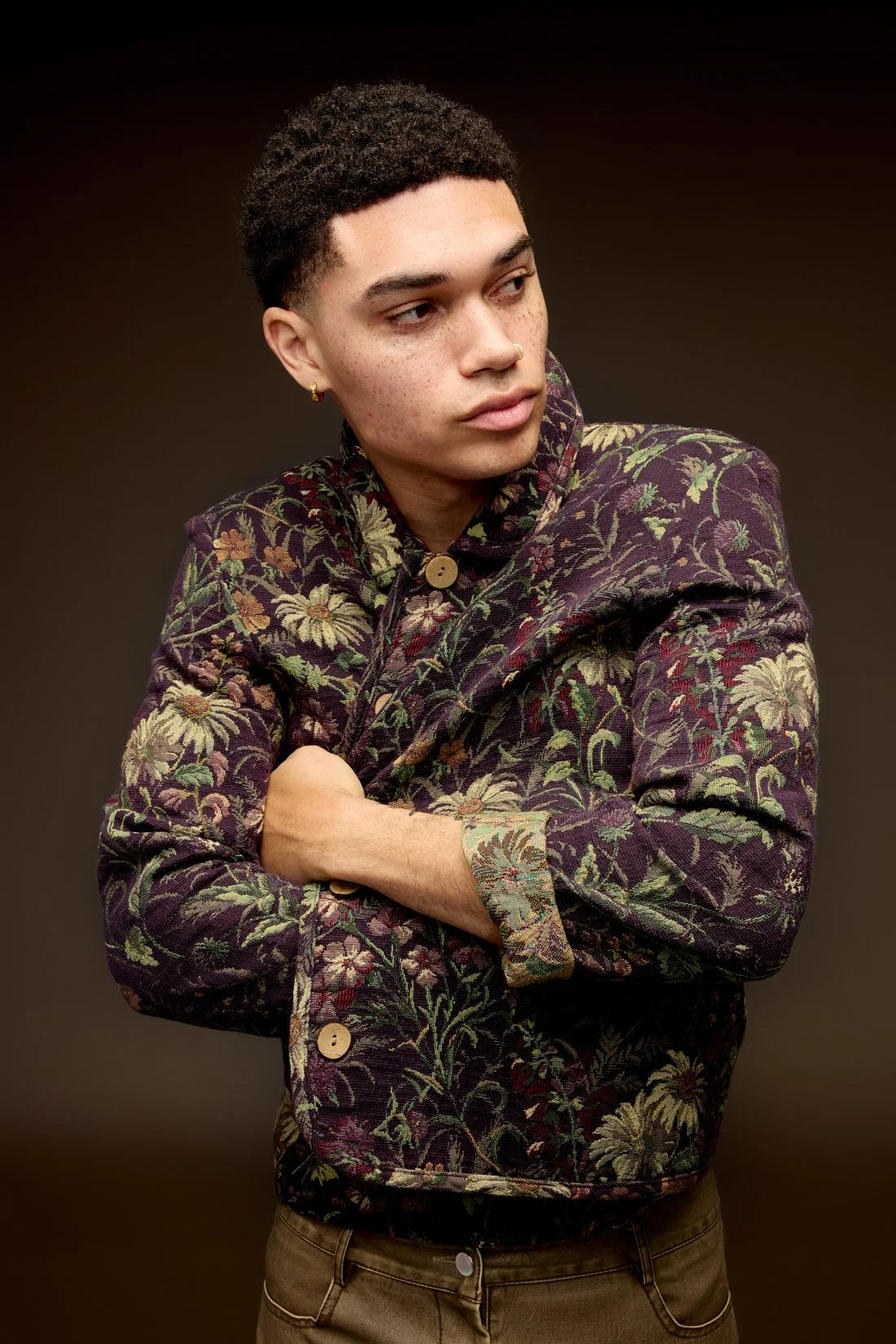 Man in a patterned jacket, warm-toned studio portrait