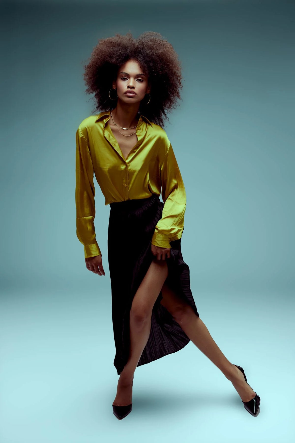 Natural curls, chartreuse blouse and black skirt, full length