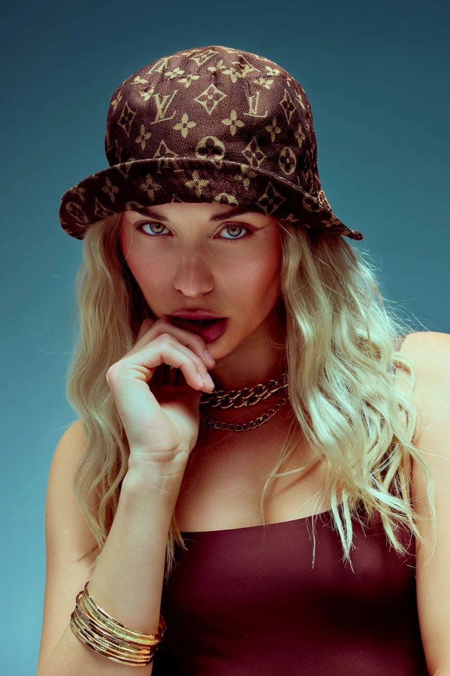 Monogram bucket hat and burgundy top, beauty close-up