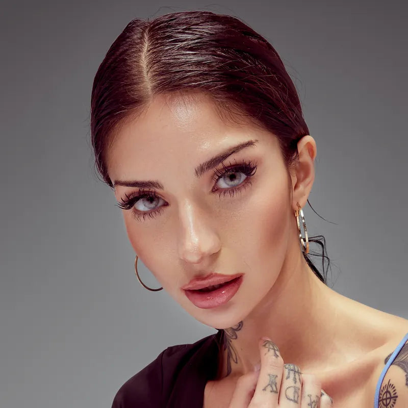 Beauty portrait with burgundy hair and fine-line tattoos